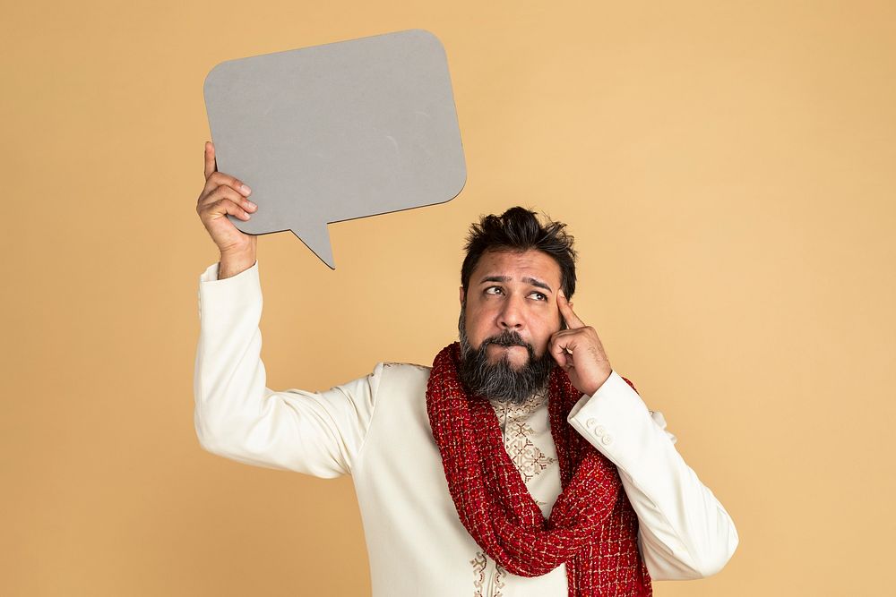 Thoughtful Indian man in a kurta holding a speech bubble mockup