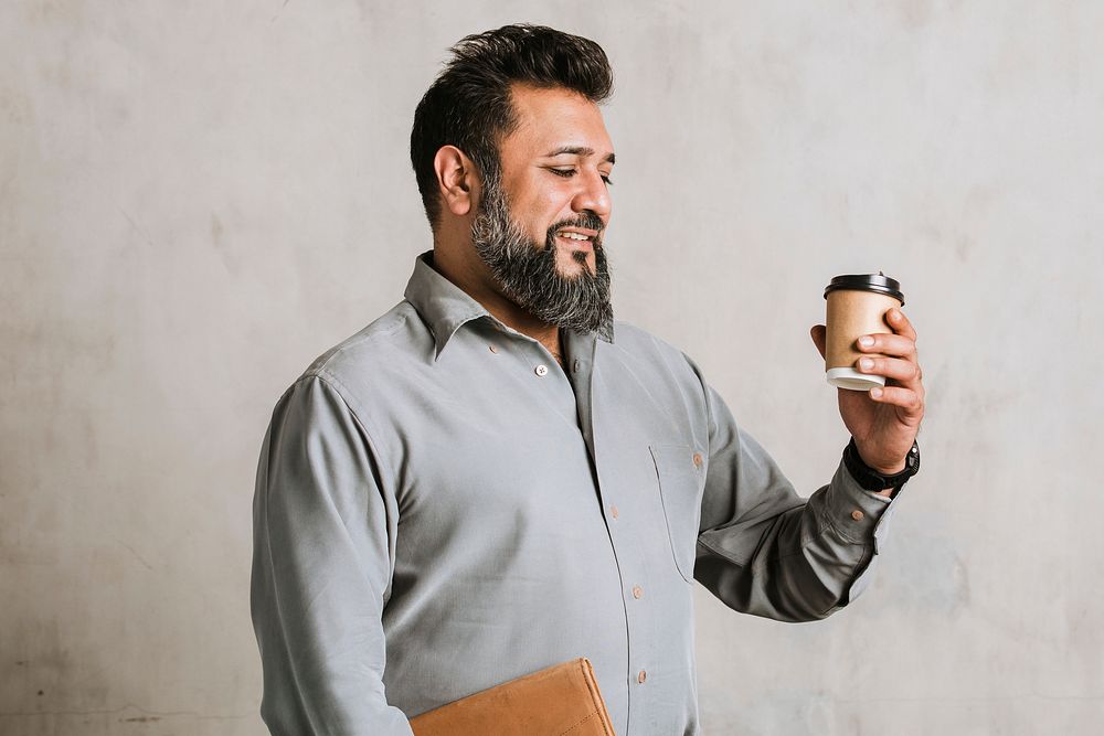 Indian businessman drinking coffee from a paper cup mockup 