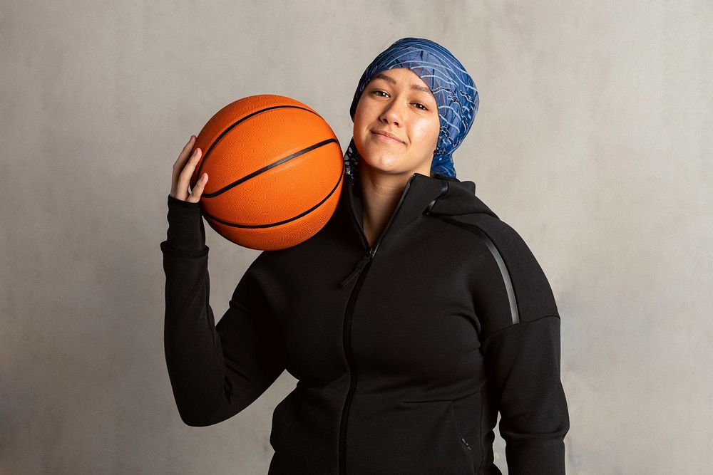 Muslim woman holding a basketball