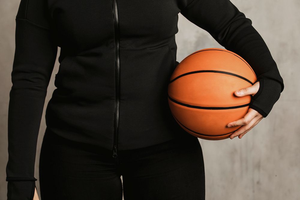 Sporty woman holding a basketball 
