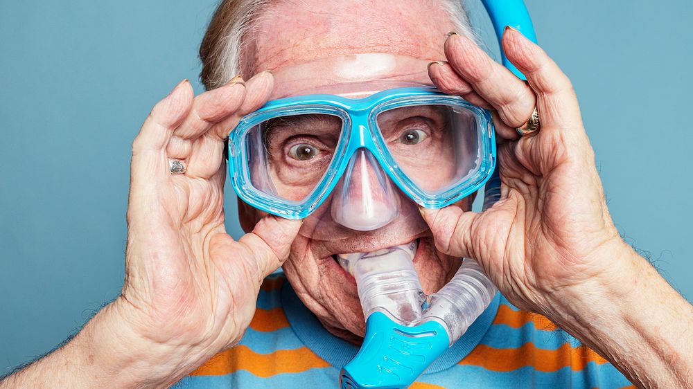 Funny senior man wearing snorkeling goggles