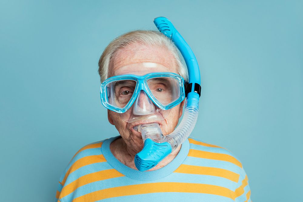 Senior man wearing snorkeling goggles