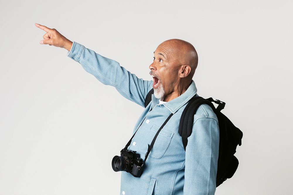 Excited black senior man with a digital camera 