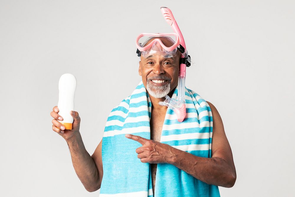 Senior African American man holding a sunscreen lotion bottle
