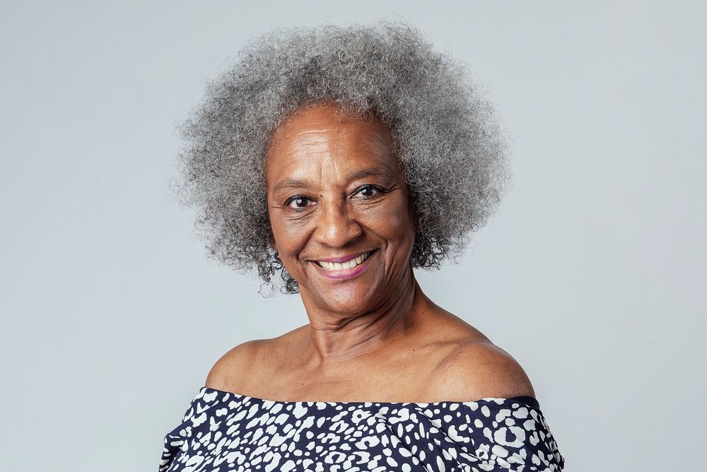 Happy black senior woman in a studio shoot 