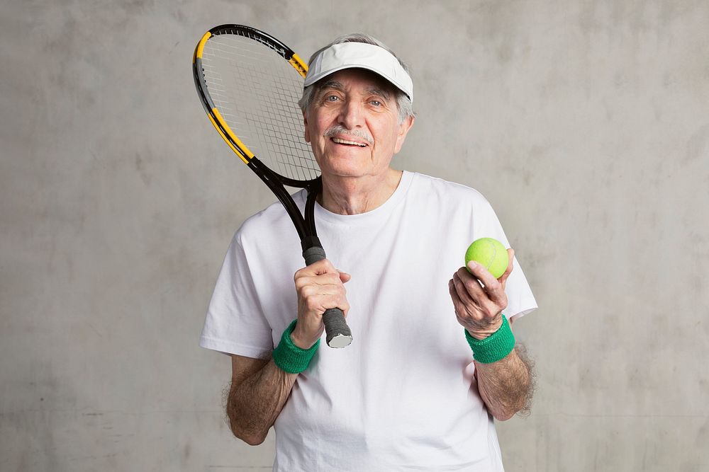 Cheerful senior tennis player wearing a visor cap 