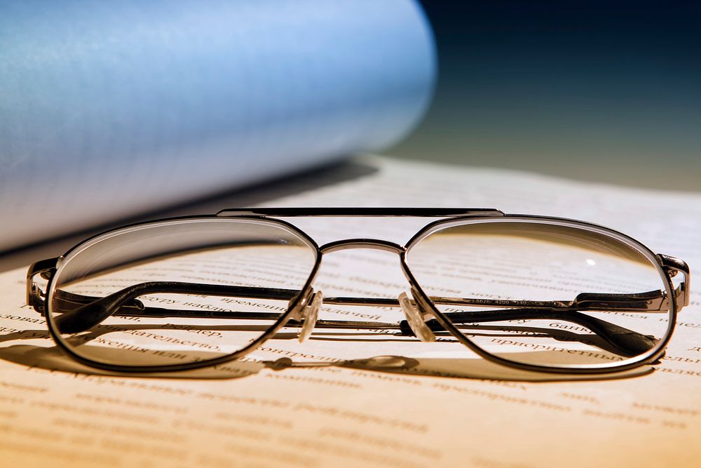 Reading glasses on book, free public domain CC0 image.