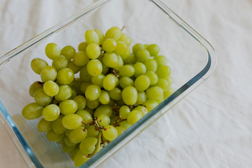 Bunch of green grapes in a glass bowl