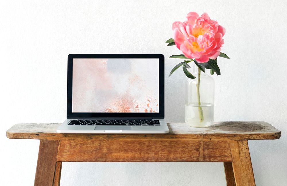 Blank laptop screen mockup by a pink peony