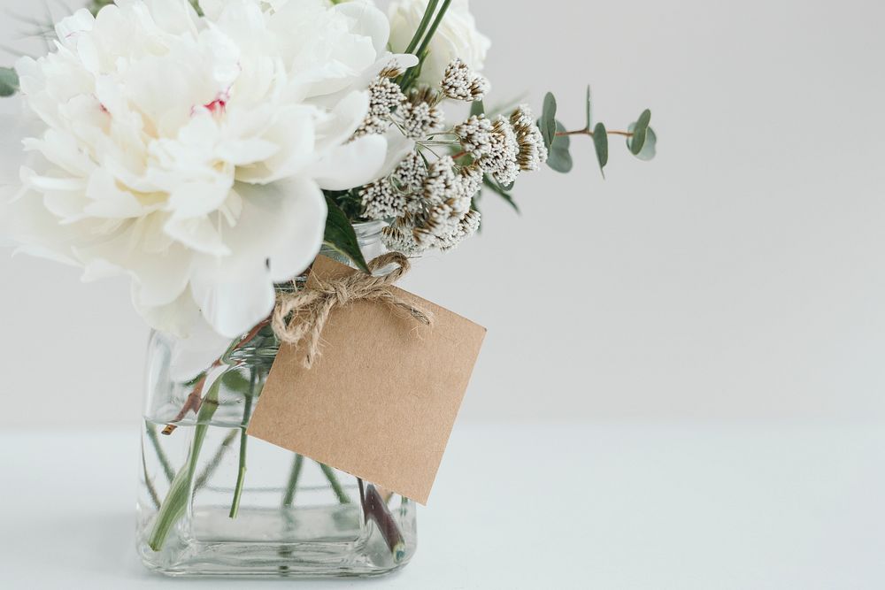 Vase of white flowers with a craft card mockup