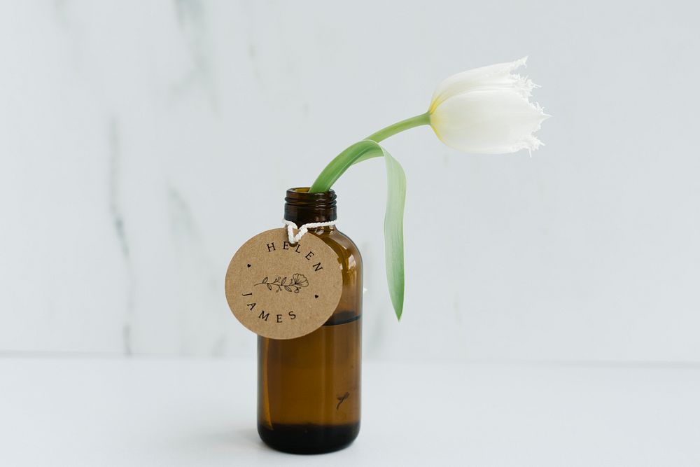 White parrot tulip in a brown glass bottle
