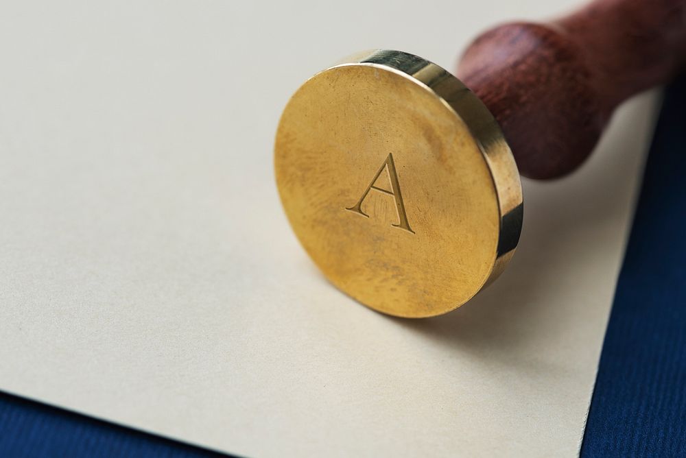 Vintage gold wax seal stamp with a wooden handle