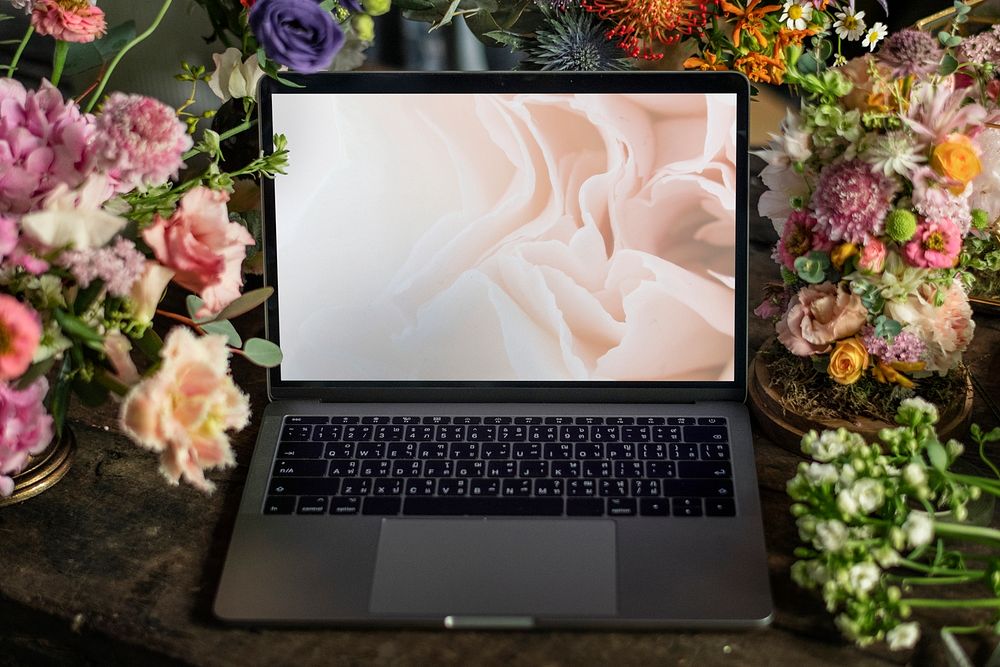 Laptop screen mockup surrounded by flowers