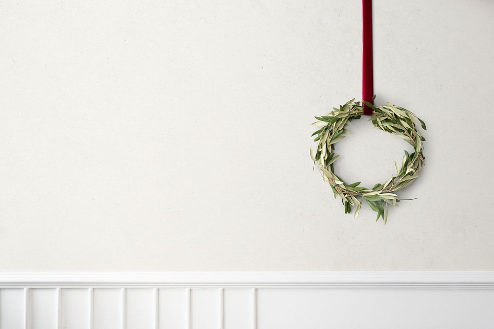 Eucalyptus Christmas wreath hanging on a white wall