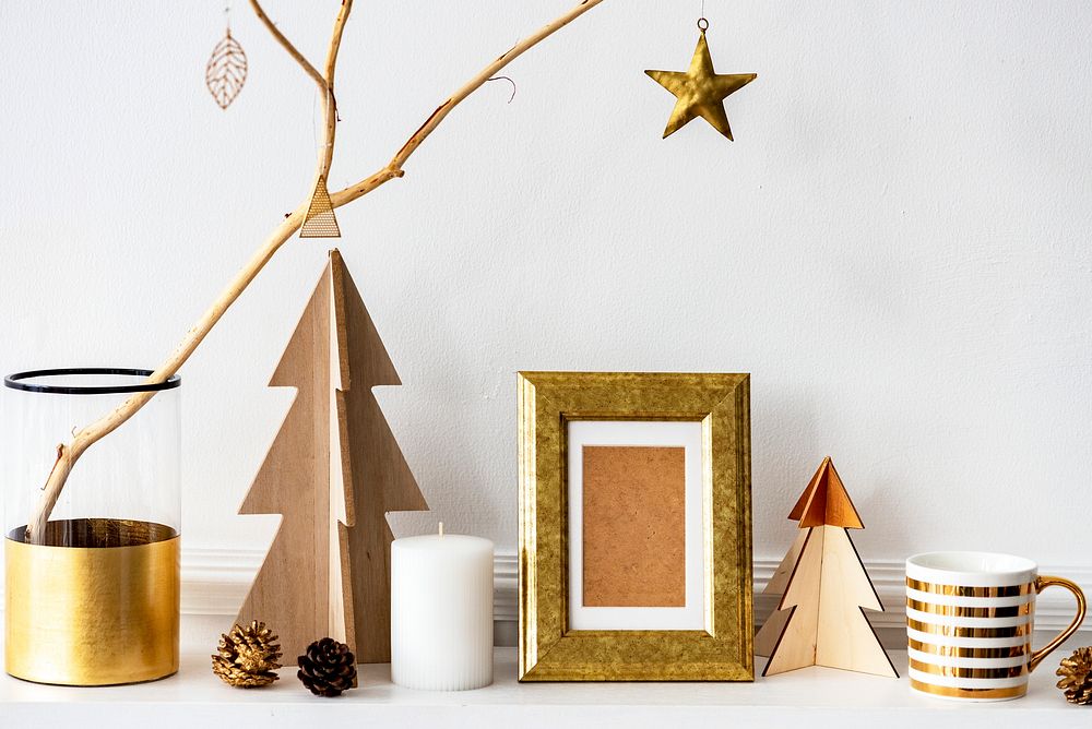 Golden photo frame surrounded by Christmas decor