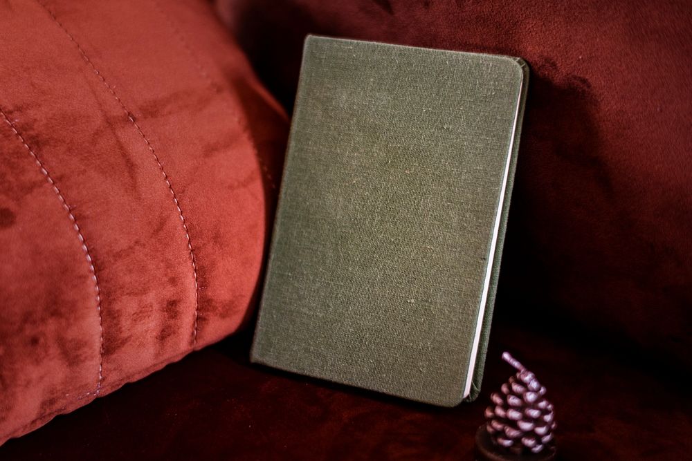 Gray textured book cover by a red quilt