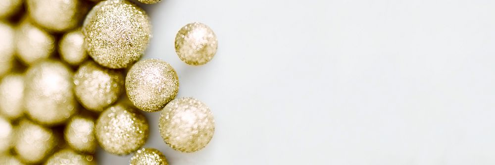 Glittery golden baubles isolated on background