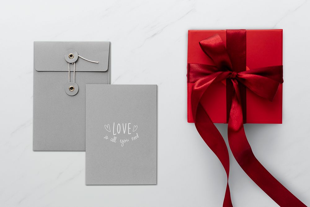 Red present by gray envelopes mockup