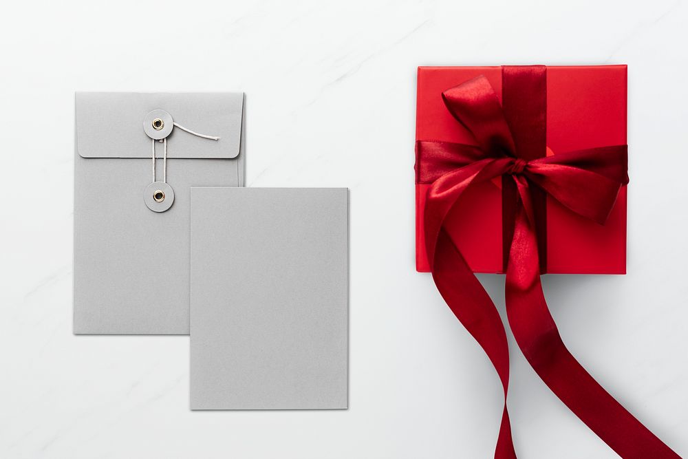 Red present by gray envelopes
