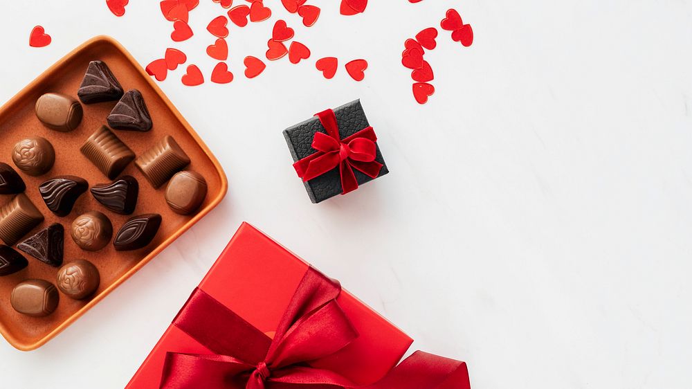 Chocolates by a box of red present wallpaper