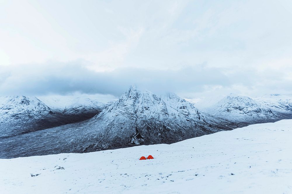 Orange tents at a snowy mountain