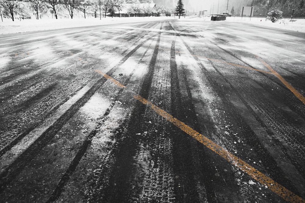 Street covered with car tire tracks in the snow