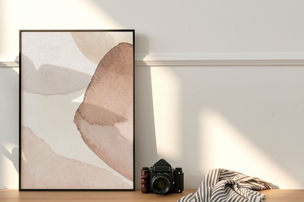 Picture frame mockup on a wooden sideboard table by an analog camera 