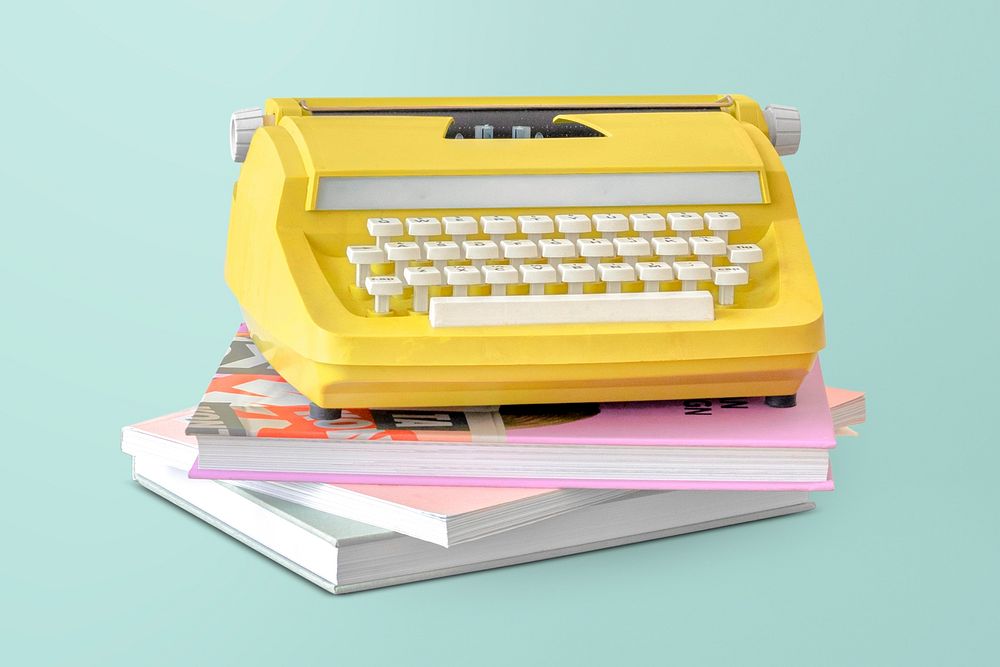 Vintage yellow typewriter mockup on a stack of books 