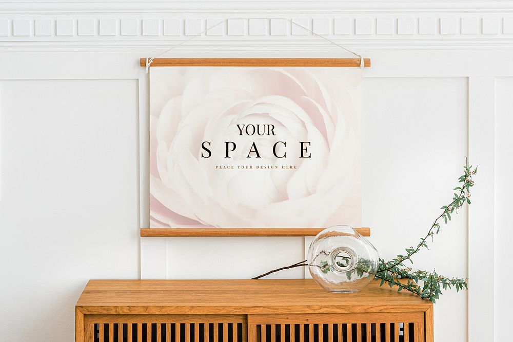 Blank frame mockup hanging above a wooden cabinet