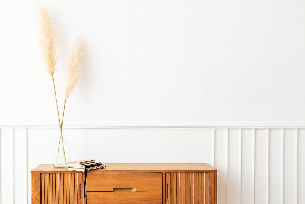 Pampas grass in a vase on a wooden sideboard table 