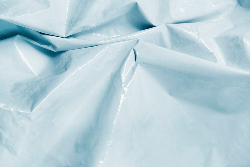 Sky blue crumpled plastic textured textile background