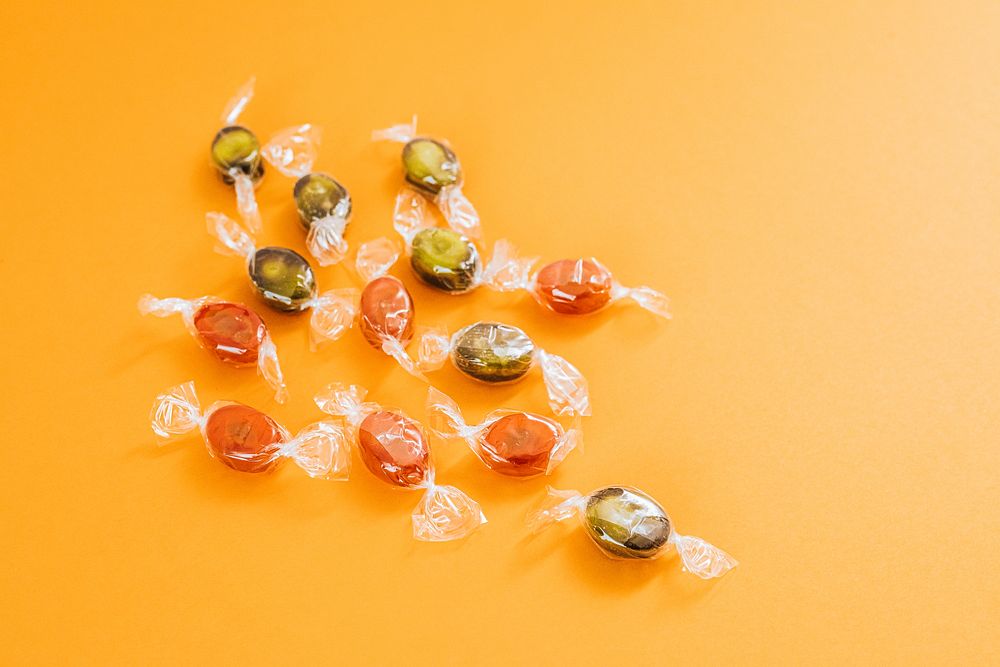 Halloween candies on an orange background design resource 