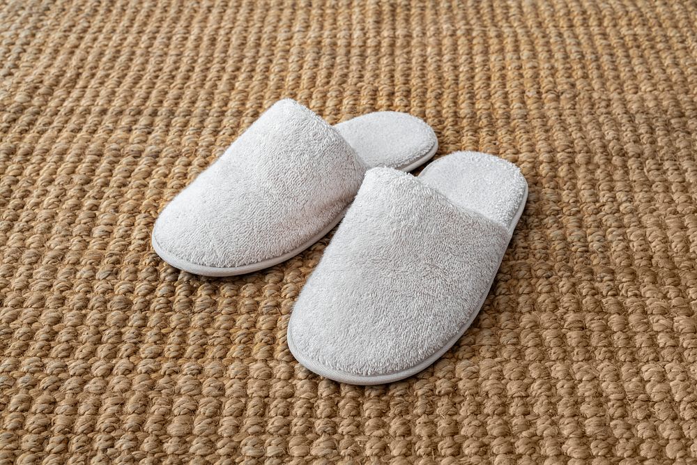 White indoor slippers on jute rug