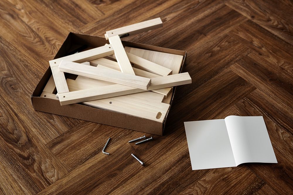 Ready-to-assemble chair and instruction book on the floor