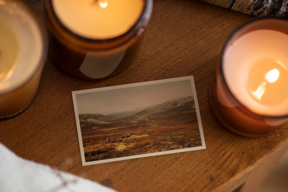 Mountain landscape photo film on a table with scented candles