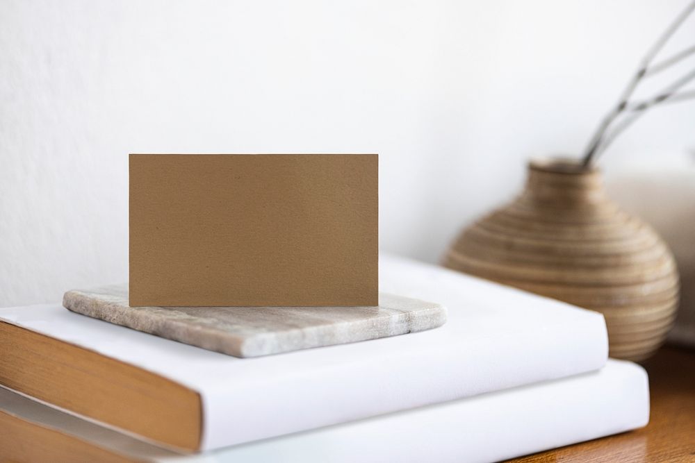 Business card with calm aesthetics on a table with design space