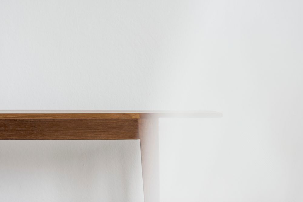 Wooden dining table against the wall with design space