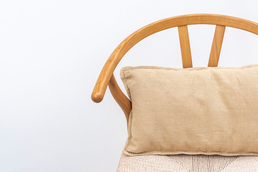 Minimal linen cushion cover in beige on a chair