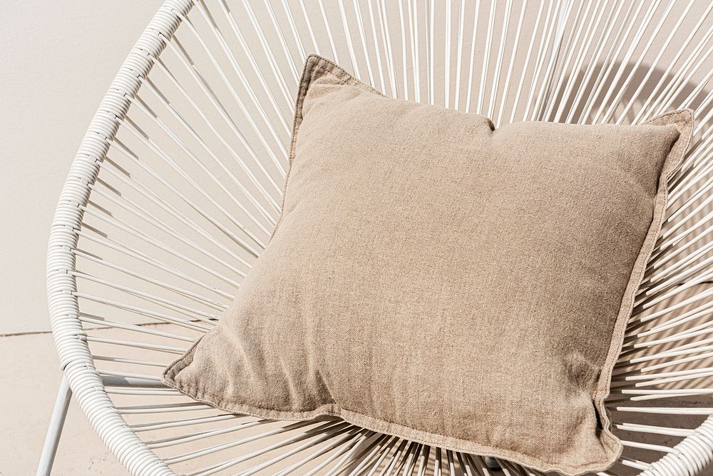 Beige printed cushion on a chair minimal interior design