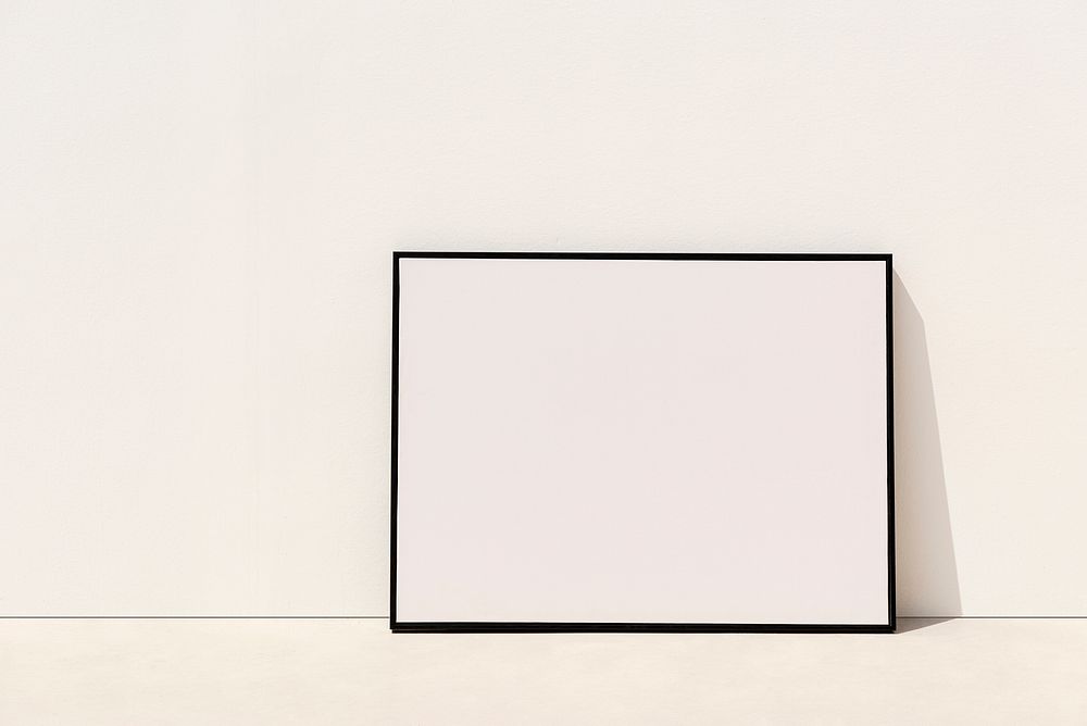 Blank picture frame leaning against the wall 