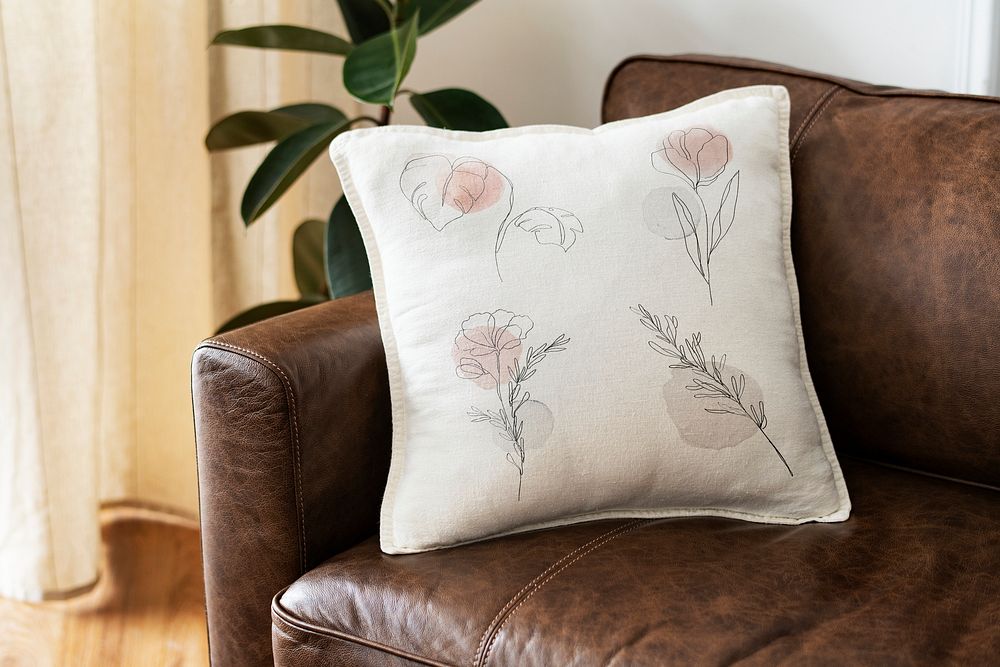 Cushion cover mockup psd on a leather couch