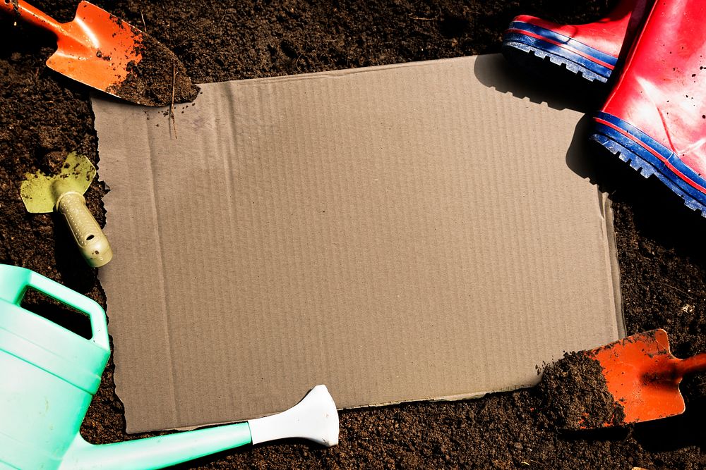 Blank cardboard on a garden soil