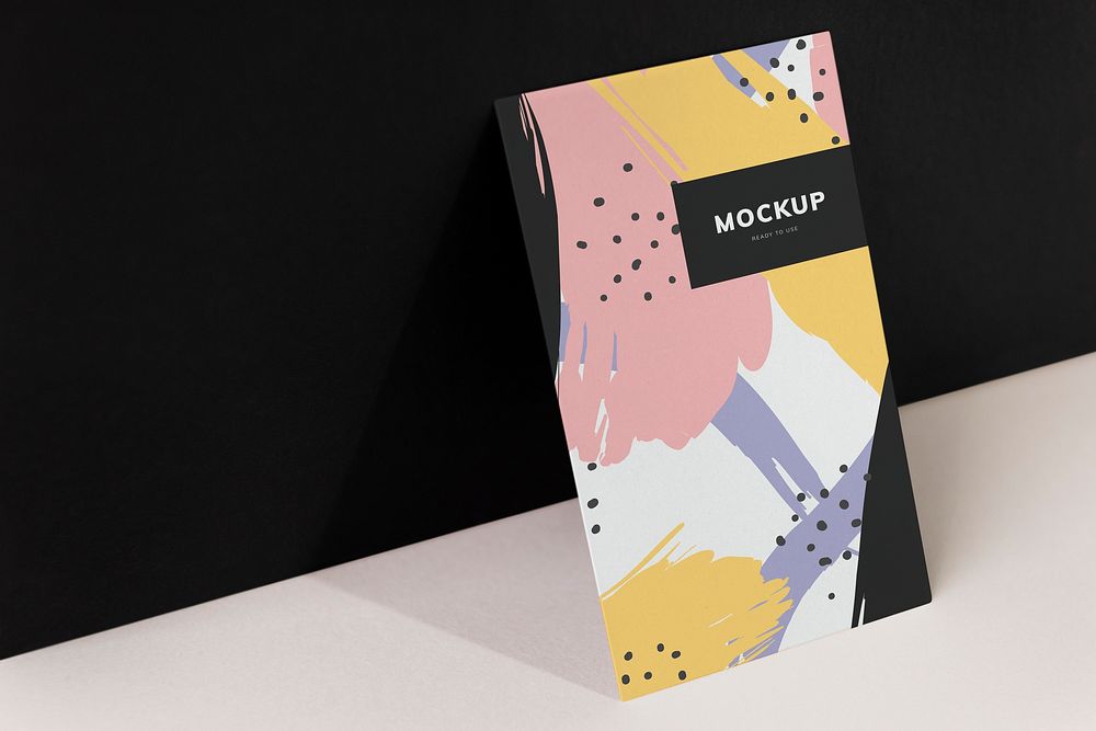 Colorful paperboard mockup against the black wall