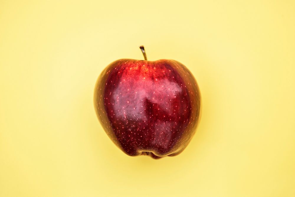 Apple on yellow background