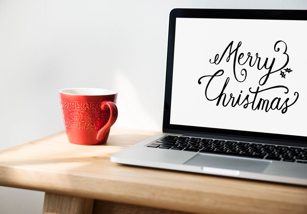 Closeup of computer laptop with Merry Christmas words