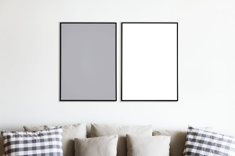 Two photo frames isolated on white wall