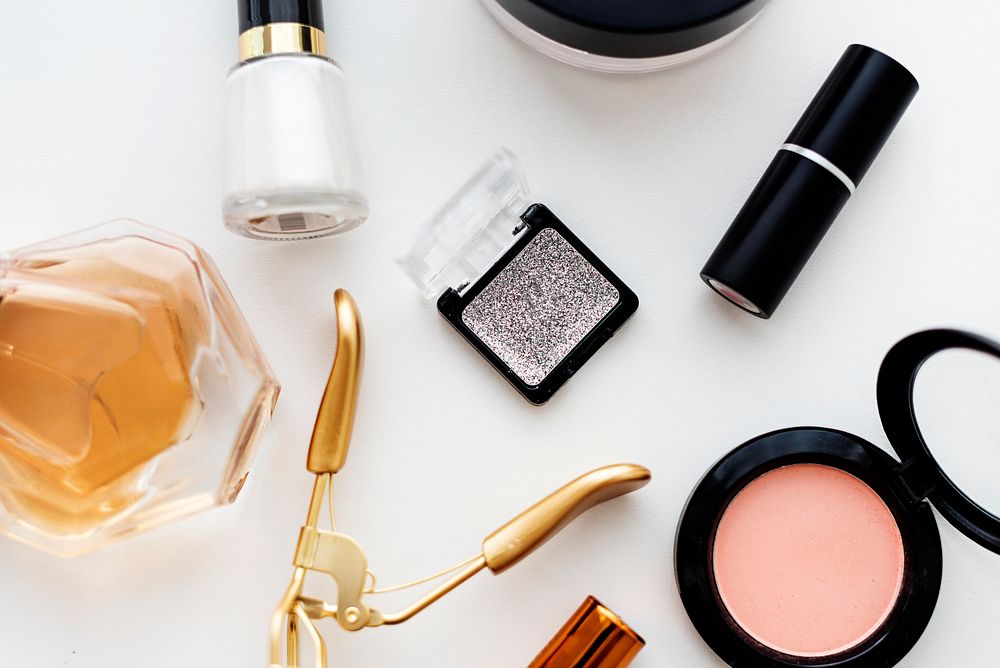 Various makeup products on white table