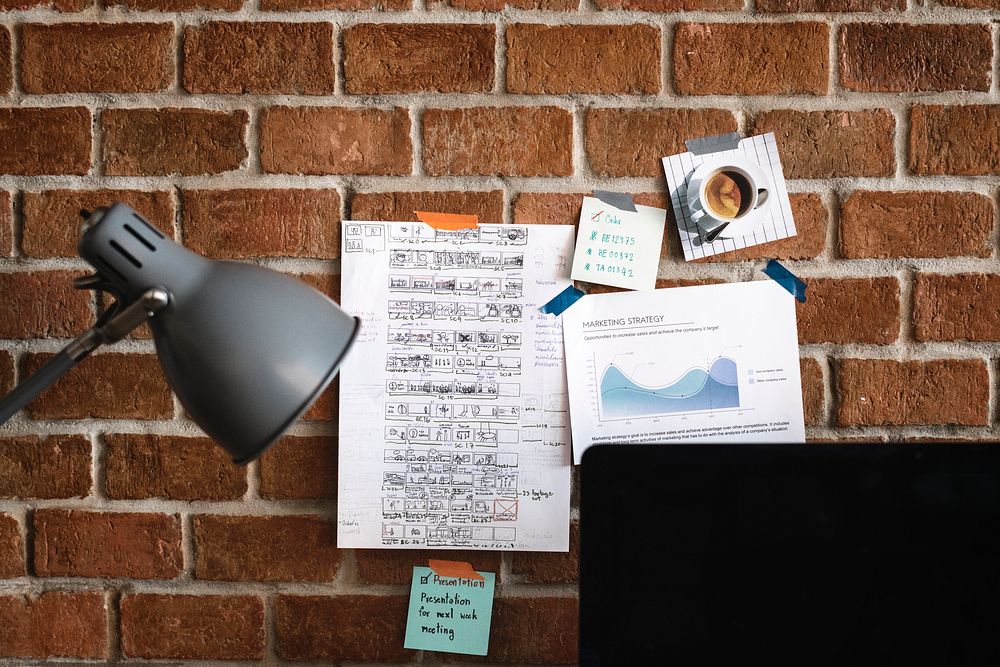 Workspace with note on brick wall