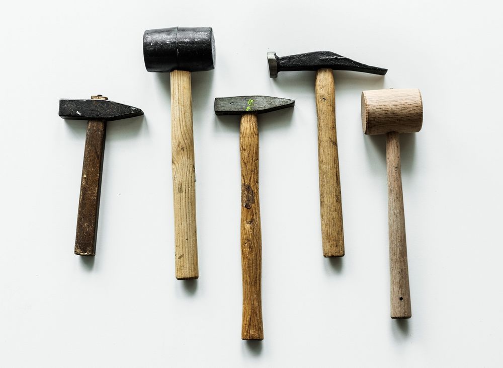 Flat lay of various hammers isolated on white background