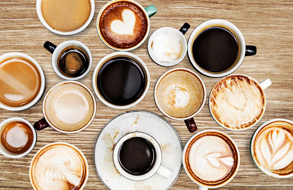 Assorted coffee cups on a wooden table